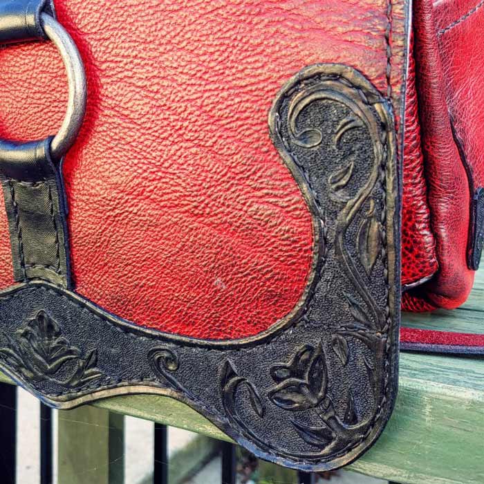 Red and black leather badass bag corner tooling detail.
