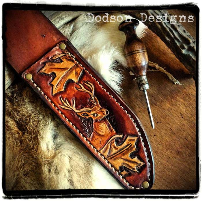 Hand-tooled leather knife sheath depicting a dear and leaves.