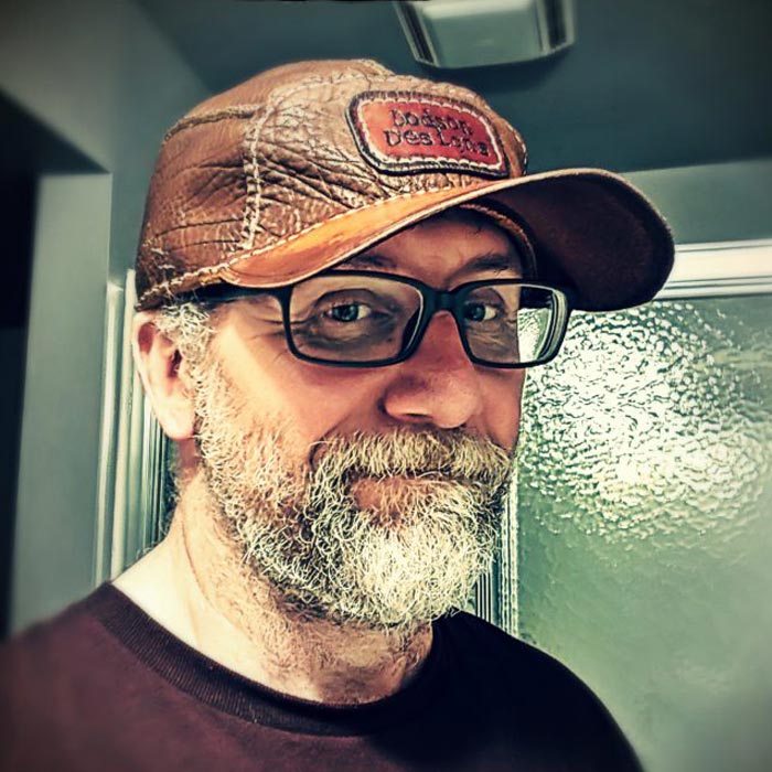 Don wearing a brown leather ballcap with a Dodson Design logo patch.