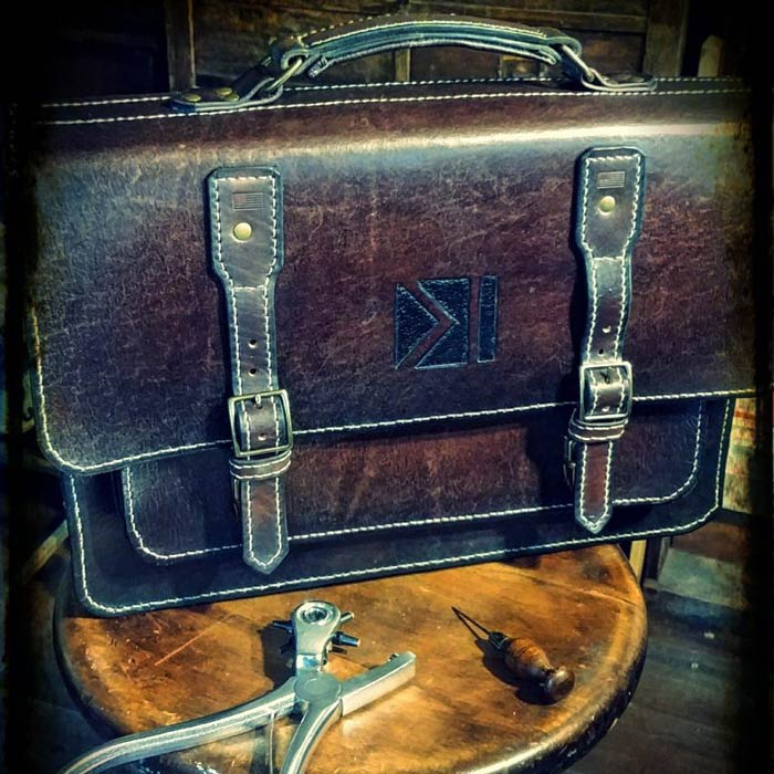 Dark brown leather briefcase with 2 buckle closures.