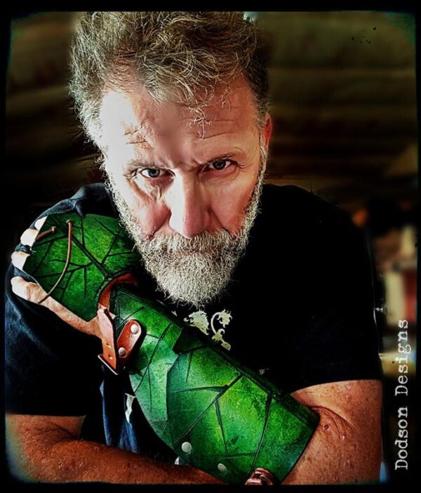 Don wearing a green leaf leather bracer.
