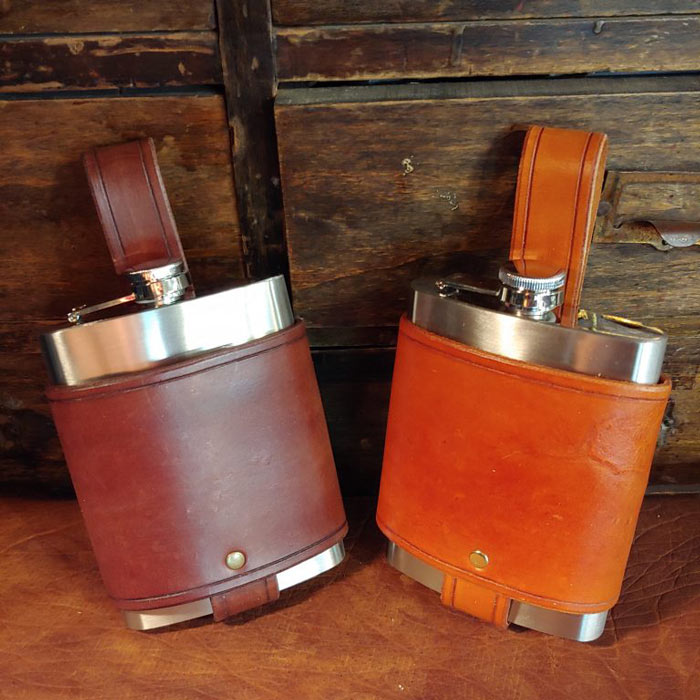 2 flask holders in non tooled dark brown and reddish brown leather.