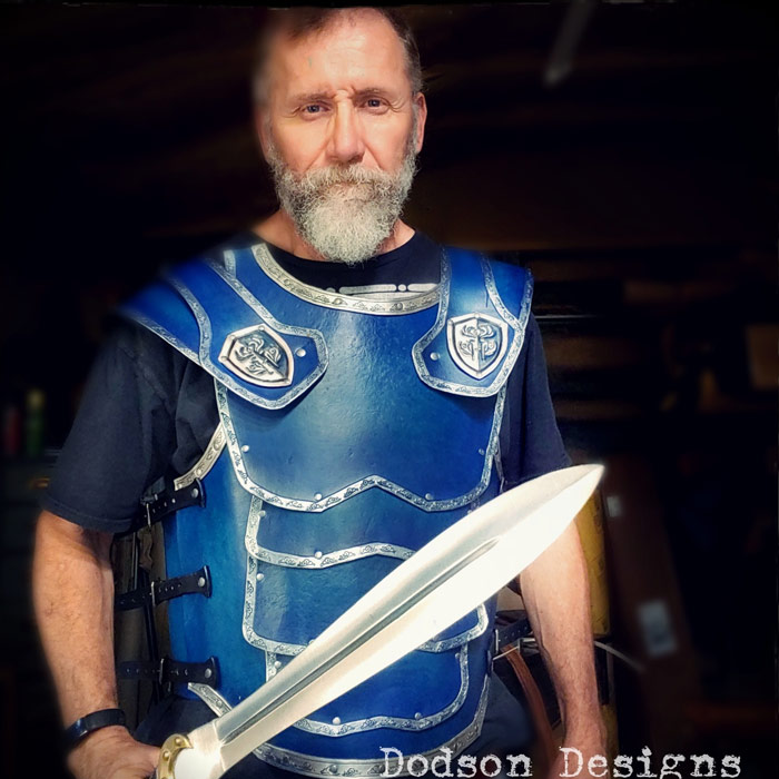 Don wearing blue gladiator inspired leather armor.