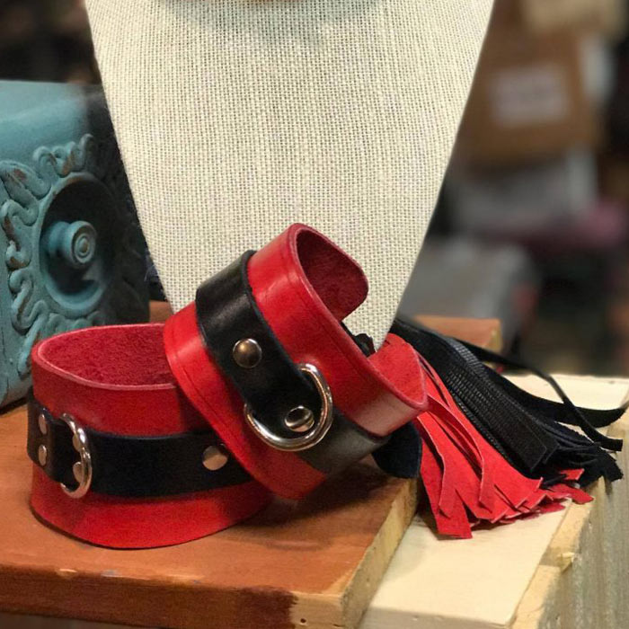 Red and black leather cuffs with tassels.