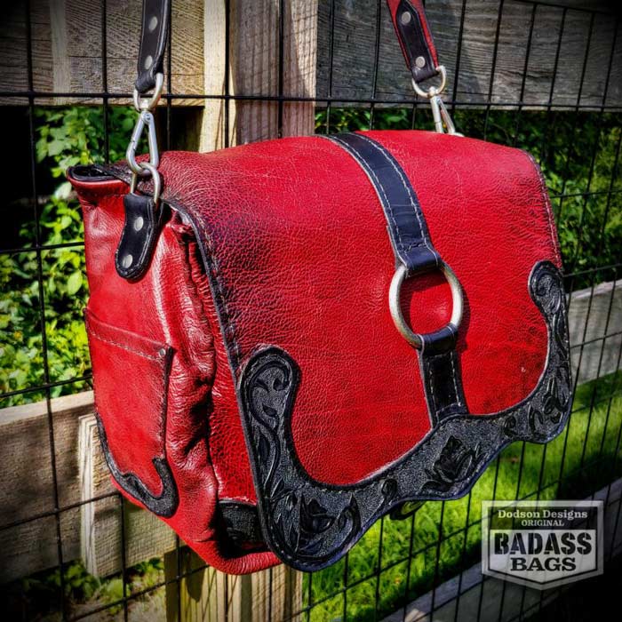 Soft red leather messenger bag with black strap and accents.